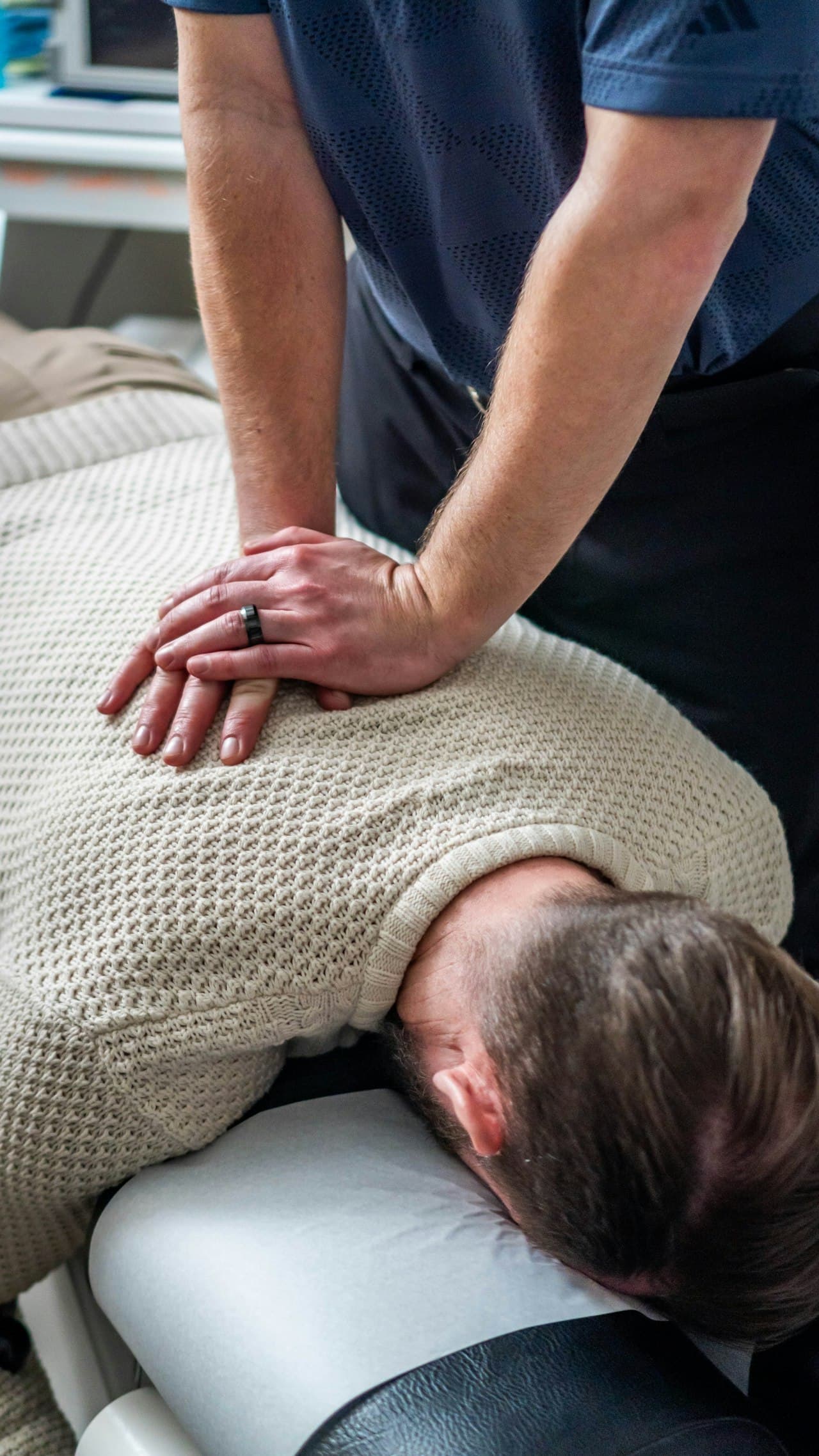 Chiropractor performing a spinal adjustment on a patient at The Accident Doctor's Phoenix clinic