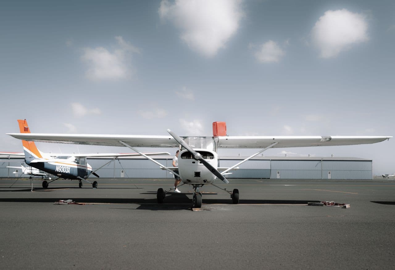 Small single-engine general-aviation propeller airplane parked on an airport tarmac